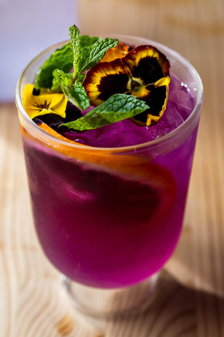 Gamba Drink: The Mystery - 80k Butterfly Pea flower tea, vodka, lemon juice, tonic water, and sparkling water.